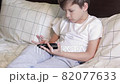 sleepy child uses smartphone instead of sleep 82077633