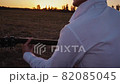 Alone man playing guitar outdoors at sunset time 82085045
