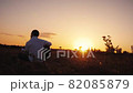 Alone man playing guitar outdoors at sunset time 82085879