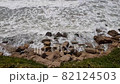 Beautiful waves and Mediterranean stony coast. Top down aerial view of sea waves crashing and foaming. 82124503