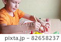 Making pumpkin from seeds on white paper, Halloween DIY concept 82658237