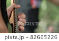 Hands of a man playing an electronic guitar 82665226