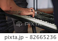 Hands of a man playing a synthesizer 82665236