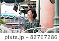 Senior couple meeting on the terrace and having a fun conversation while looking at their smartphones 82767286