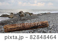 Severe storm on the sea and sky with thunderclouds and a wooden log in the foreground. 82848464