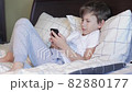 Cute child boy having conversation by video call 82880177