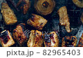 Mushrooms and meat grilling on a barbecue, top view 82965403