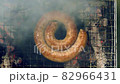 South African style sausage coil grilling on a barbecue, top view 82966431