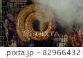 South African style sausage coil grilling on a barbecue, top view 82966432
