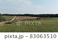 Aerial panorama of rural road passing through agricultural land and pasture fields in Latvia 83063510