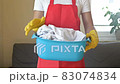 The housewife prepares to wash delicate items. The woman is holding a basin of laundry. 83074834