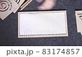 Woman hands put white sheet of paper in two-sided wooden stencil labyrinth and place stencils on top 83174857