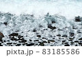 ocean waves crashing on stones at beach 83185586