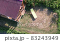 Aerial drone view over backyard with wooden summer pavilion for relaxation and sun lounger. 83243949