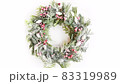 Slow motion looping rotate of Christmas snowy wreath with natural evergreen branches and holly berry.  83319989