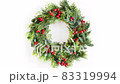 Slow motion looping rotate of Christmas wreath with natural evergreen branches and holly berry.  83319994
