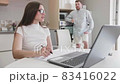 Adult caucasian couple at home in smart working and remote work job activity sitting at the desk in 83416022