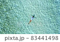 Top down view of a girl floating in a lagoon 83441498