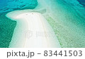 Happy woman walking on a perfect beach 83441503