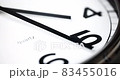 Close-up time lapse of a  modern wall clock. Selective focus on the number 5 or 5 o'clock. Reflections in the aluminum frame of the watch. Time is running fast. The time from 4 to 6 on a clock. 83455016