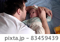 Caucasian father man brushing hair of cute baby girl 83459439