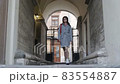 Young beautiful girl walks the street of the old city. Excursion to the old town 83554887