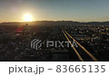 Sunset falling on the mountains of the Kyoto basin and a car running on the highway (drone aerial fixed point shooting) 83665135