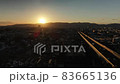 Sunset falling on the mountains of the Kyoto basin and a car running on the highway (drone aerial photography, descent photography) 83665136