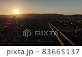 Sunset falling on the mountains of the Kyoto basin and a car running on the highway (drone aerial photography time lapse) 83665137