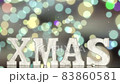 The letters XMAS rotate on a glowing colored bokeh background. 83860581