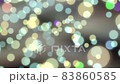 Glowing colored bokeh background with floating light particles 83860585