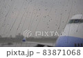 Raindrops motion on glass window with airplane on the background 83871068