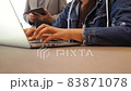 Female employee in denim jackets typing on notebook computer while boss in suit monitors behind her back. The staff stopped typing and put her head on her hand with boredom 83871078