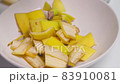 A person making banana peel fertilizer with banana cuts. A woman hand cutting banana skin into small pieces 83910081
