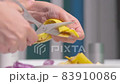 A person making banana peel fertilizer with banana cuts. A woman hand cutting banana skin into small pieces 83910086