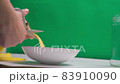 A person making banana peel fertilizer with banana cuts. A woman hand cutting banana skin into small pieces 83910090