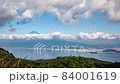 Clouds boiling above Mt. Fuji that seems to float in the fresh green and the sea 84001619