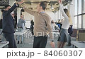 A young manager enters the office, dances, scatters documents. Colleagues get up from work, go and dance together. Corporate party. Start of vacation. The end of the work. Office life. Coworking 84060307