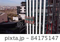 Suspended cradle and workers on the building construction 84175147
