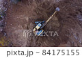 Excavator digs the ground 84175155