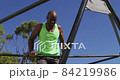African american senior couple playing tennis on the tennis court on a bright sunny day 84219986