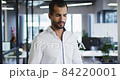 Portrait of caucasian businesswoman standing in office holding paperwork smiling to camera 84220001