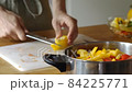 Man cooking fresh food at home. Closeup chef hands slicing pepper in slow motion. Male professional preparing vegetables with knife at home kitchen 84225771