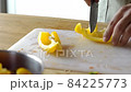 Man cooking fresh food at home. Closeup chef hands slicing pepper in slow motion. Male professional preparing vegetables with knife at home kitchen 84225773