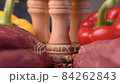 Extreme macro shot of slide between two raw beef fillets on wooden board with colorful background 84262843