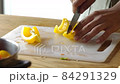 Man cooking fresh food at home. Closeup chef hands slicing pepper in slow motion. Male professional preparing vegetables with knife at home kitchen 84291329