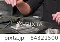 Close Up of Hands of Jeweler Packing Order 84321500