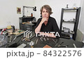 Pensive Jeweler Posing in Studio 84322576