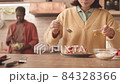 Multiethnic Couple Making Breakfast at Home 84328366