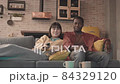 Multiethnic Couple Watching TV at Home 84329120